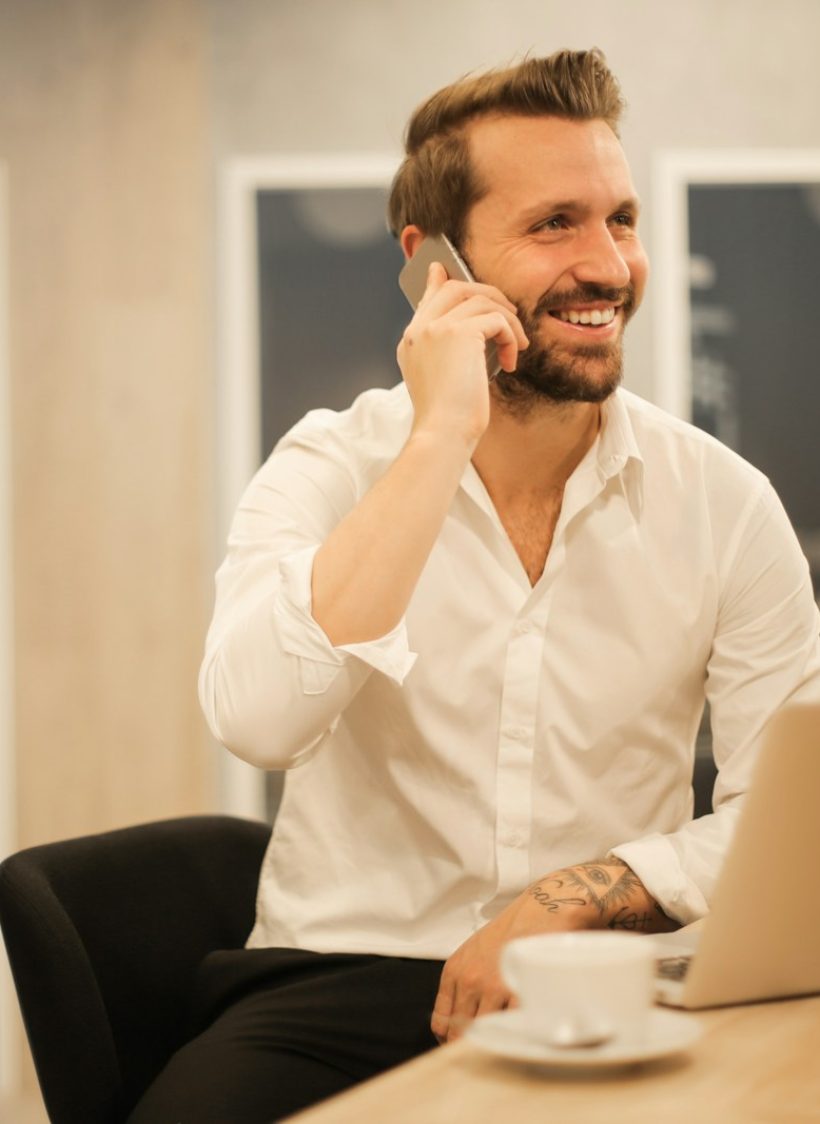 man using smartphone on chair